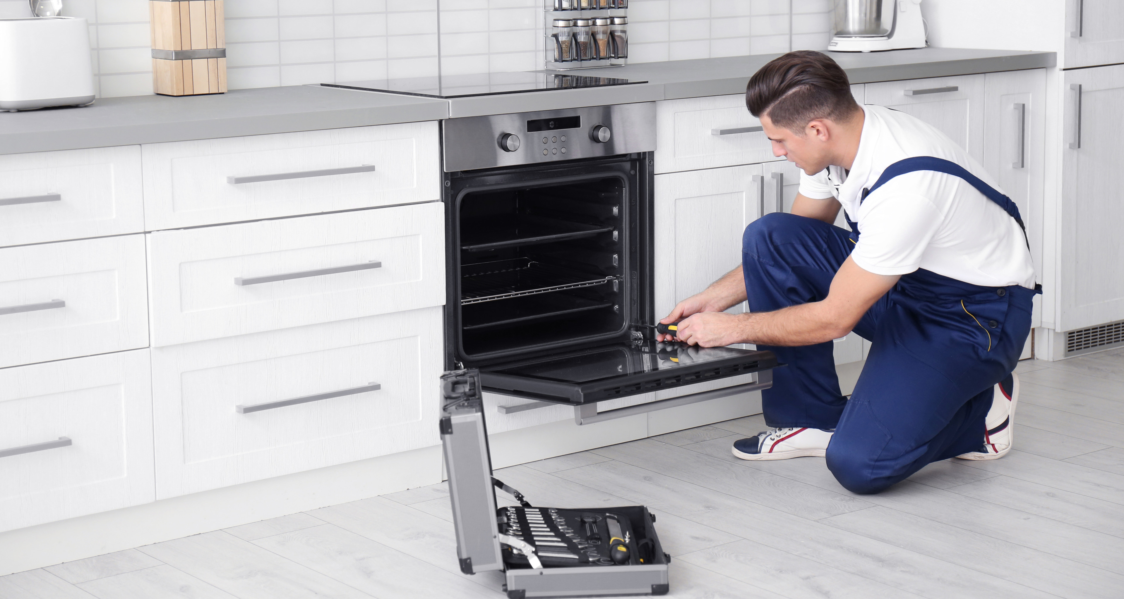 Technician repairing an oven