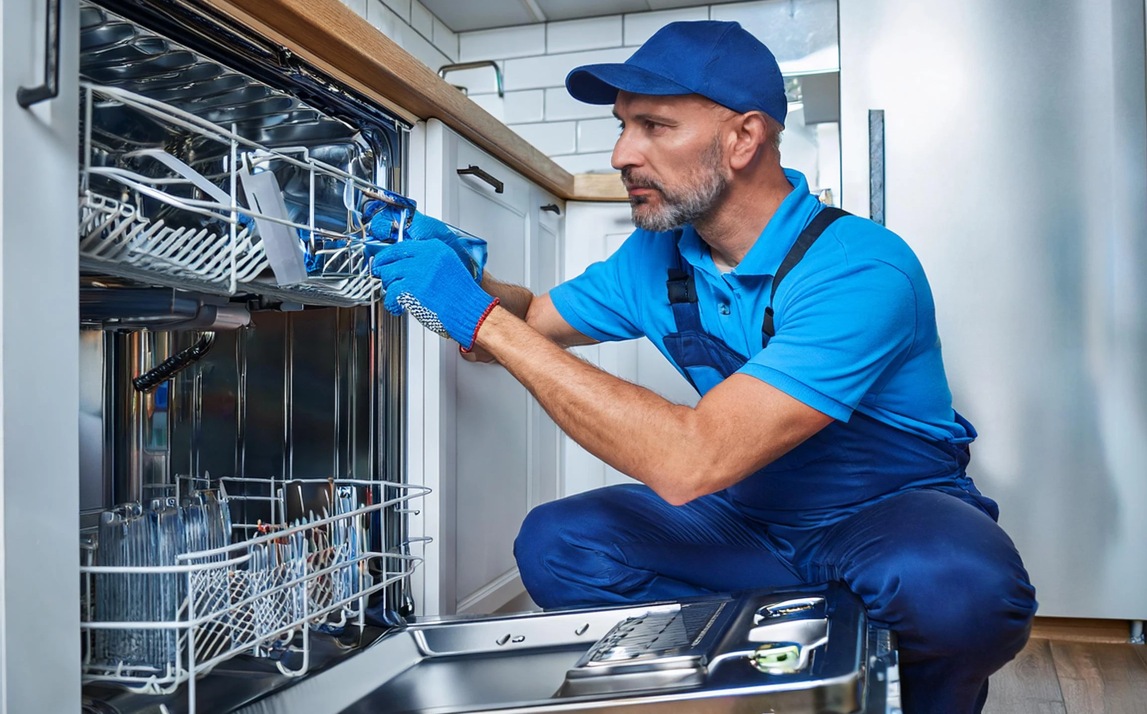 Technician repairing dishwasher